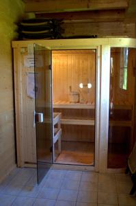 an inside view of a sauna with a glass door at Lärchenhütte in Tauplitzalm