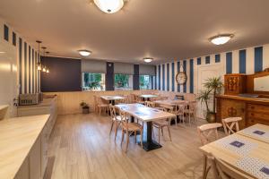 a restaurant with tables and chairs in a room at Farys in Jastrzębia Góra