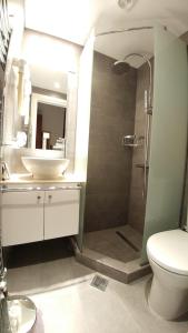 a bathroom with a shower and a sink and a toilet at Hotel Galaxidi in Galaxidi