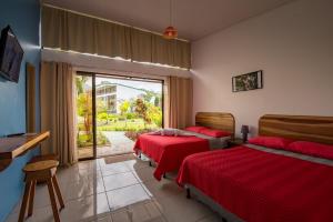 a bedroom with two beds and a large window at Hotel Secreto La Fortuna in Fortuna