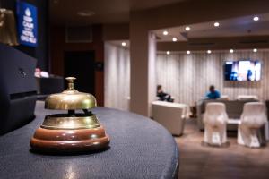 a bell sitting on top of a table in a lobby at Hotel Oro Blu in Milan