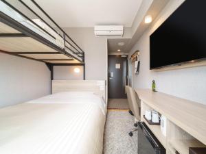 Postel nebo postele na pokoji v ubytování Super Hotel Shonan Fujisawaeki Minamiguchi