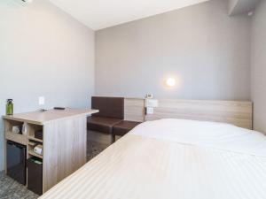 Postel nebo postele na pokoji v ubytování Super Hotel Shonan Fujisawaeki Minamiguchi