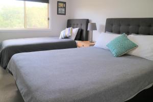 a bedroom with two beds and a window at SkyLodge Temora in Temora