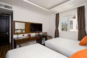 Postel nebo postele na pokoji v ubytování Roliva Hotel & Apartment Danang