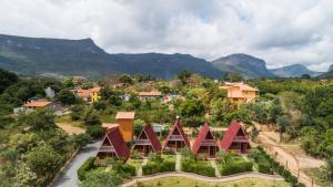 an aerial view of a resort with mountains in the background at Pousada e Hostel Pé no Mato in Vale do Capao