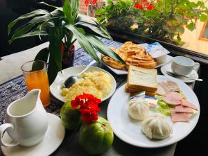サパにあるYouth Homestay Sapaの食べ物や飲み物の皿が置かれたテーブル +18枚の写真