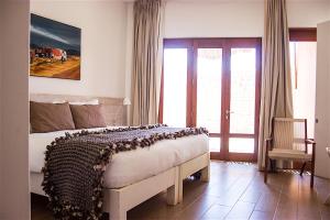 a bedroom with a bed in a room with a window at NOI Casa Atacama in San Pedro de Atacama