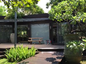 a picnic shelter with a picnic table in a garden at The House 15 Villa in Hengchun South Gate