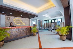 a woman standing at a bar in a restaurant at Sungthong Kamala Beach Resort in Kamala Beach +37 photos