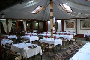 a dining room with white tables and chairs at Marco Polo, Cahul in Cahul