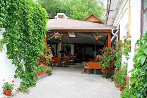 an outdoor patio with flowers and a table and chairs at Marco Polo, Cahul in Cahul