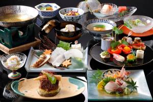 a table with several plates of food on it at Tsukihitei in Nara