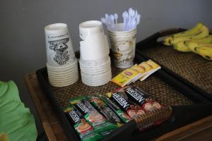 a table with a tray of snacks and cups and bananas at @The Pier 519 Hostel in Phi Phi Islands