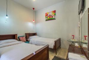 Ένα ή περισσότερα κρεβάτια σε δωμάτιο στο Jeng Tini Guest House