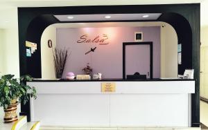 a store front with a pink and black wall at Salsa Resort Langkawi By Casa Loma in Pantai Cenang
