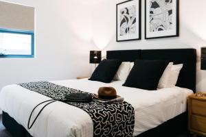 a bedroom with a bed with a person sitting on it at Gabba Central Apartments in Brisbane