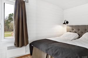 a bedroom with a bed and a window at First Camp Karlstorp-Halmstad in Halmstad