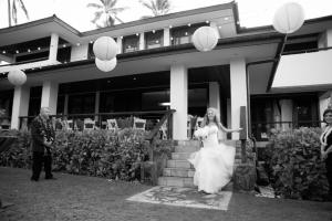 a bride and groom standing in front of a building at Villa Koa - Hale Koa LUXURY Beachfront in Laie