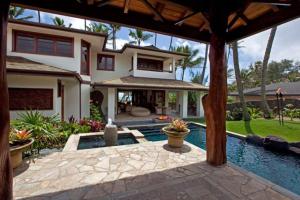 a house with a swimming pool in front of a house at Villa Koa - Hale Koa LUXURY Beachfront in Laie