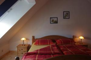 a bedroom with two beds with red pillows at Alte Bäckerei in Monschau