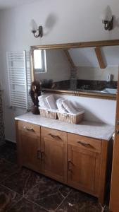 a bathroom with a mirror and a counter with baskets at Holiday home Vila Bjelašnica in Bjelašnica