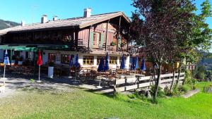 a building with tables and chairs in front of it at Gasthof Seeweg in Oberstdorf