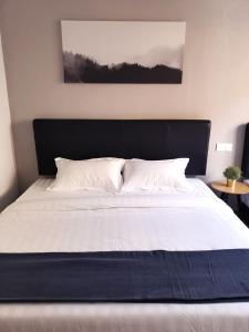 a large bed with a black headboard in a bedroom at The Core Hotel in Subang Jaya