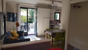 a kitchen and a living room with a table and chairs at Gîte de charme in Mirabel-aux-Baronnies