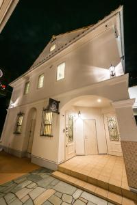 a large white building with two doors on it at Guest Villa Hakone Yumoto RiverSide in Hakone