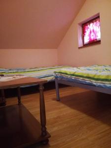 two beds in a room with a window at Epicentar, house for rent, sobe - Ivanec in Ivanec