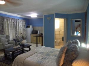 a dog laying on a bed in a bedroom at Heatherdale Guesthouse & Shuttle Services in Pretoria