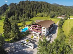 an aerial view of a resort with a parking lot at Hotel Haflingerhof in Oberau