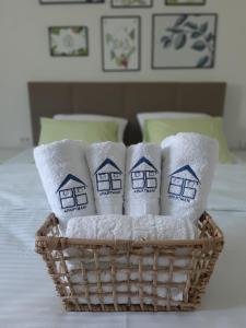 a basket of towels with drawings of houses on them at Brana Gorica Apartments in Trebinje