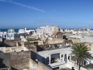 a group of buildings with the ocean in the background at Riad De La Mer in Essaouira