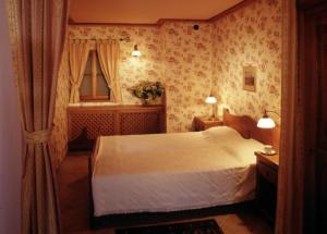 a bedroom with a large bed and a large window at Vincent Restauracja&Apartamenty in Wrocław
