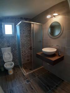 a bathroom with a sink and a shower and a toilet at Brana Gorica Apartments in Trebinje +11 photos