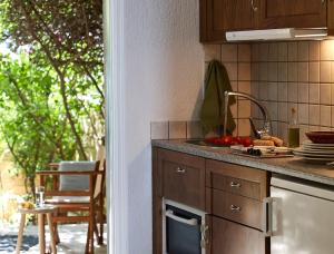 a kitchen with a sink and a counter top at Plaka Sea Front Residence in Elounda