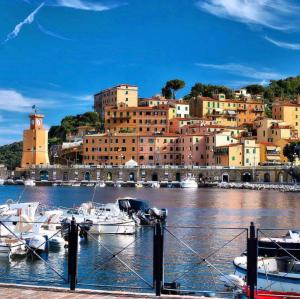 a group of boats docked in a harbor with a city at I Sentieri in Rio nellʼElba