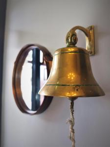 a bell hanging on a wall next to a window at Seaview House Bed and Breakfast in Larne