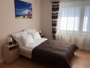 a bedroom with a bed and a red lighthouse at Willa Perła Morza in Władysławowo +55 photos