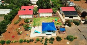 an aerial view of a miniature house with a playground at Sinai Bagolan in Giv'at Yo'av