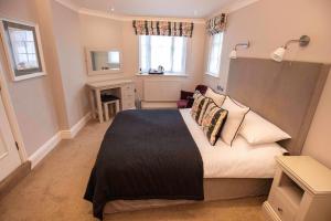 a bedroom with a bed and a desk in it at Bear Crickhowell in Crickhowell