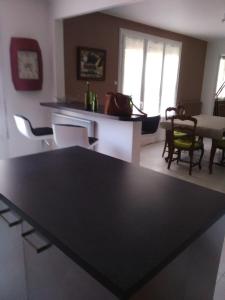 a living room with a black table and chairs at Les Palmiers in Pornic