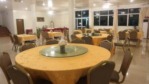 a large room with tables and chairs and tablesktop at Excelsior Resort in Dili