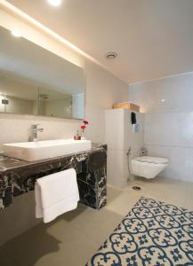 a bathroom with a sink and a toilet at Sarovar Premiere Jaipur in Jaipur