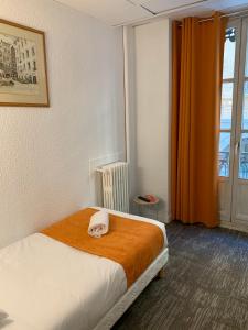 Postel nebo postele na pokoji v ubytování Hotel de Bretagne
