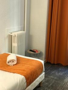 Postel nebo postele na pokoji v ubytování Hotel de Bretagne