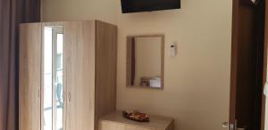 a bathroom with a mirror and a wooden cabinet at City's Center Lux. Apt.Up 6 persons and BBQ in Kavála