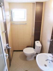 a bathroom with a toilet and a sink at Guesthouse Kolevi in Lozenets +36 photos